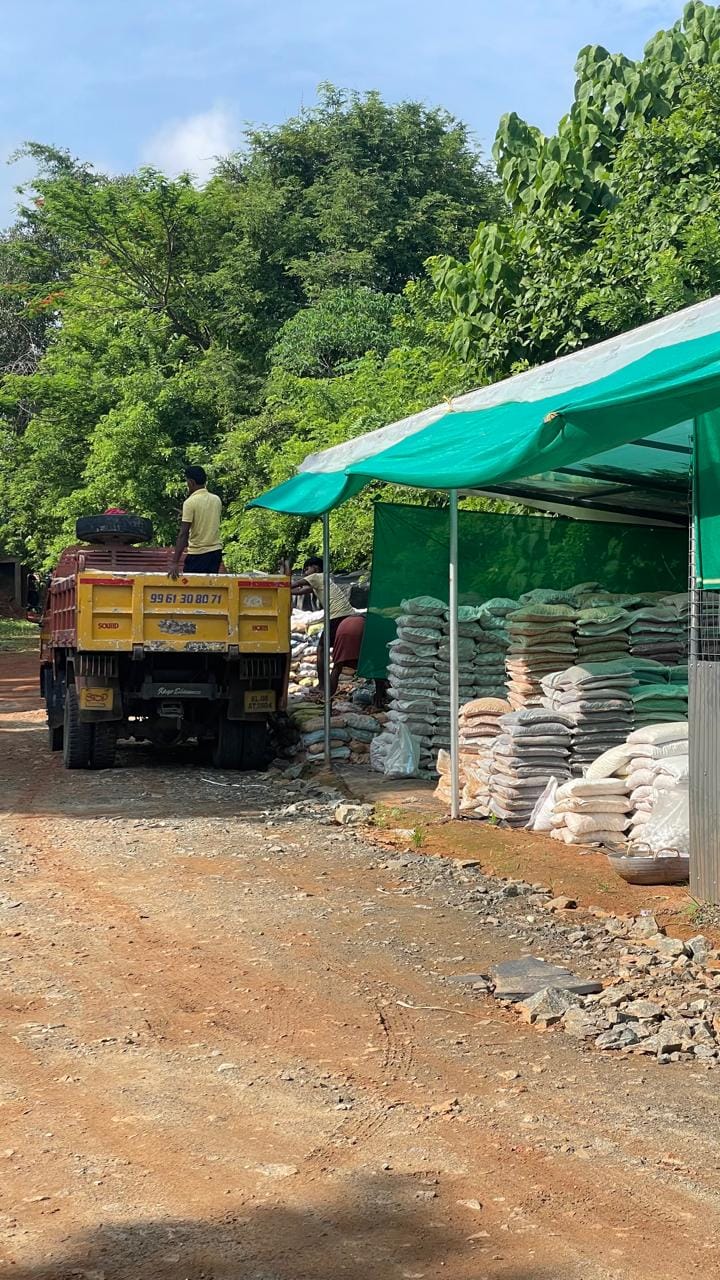 Yellow dumper truck loaded with landscaping stones at the Stone N Rocks facility in Kerala